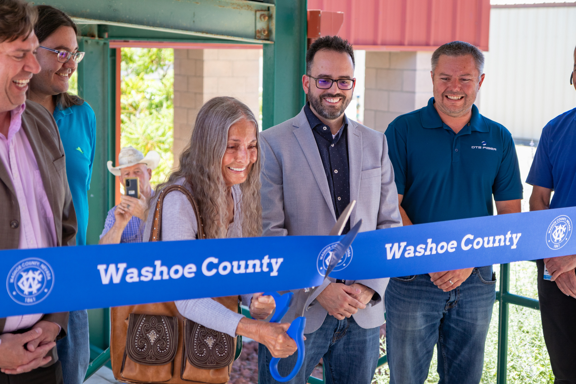 Washoe County Commissioner Jeanne Herman cuts a ribbon at the Gerlach Library celebrating the first stage of high speed internet deployment to the rural town on Tuesday, July 25, 2023. (Tim Lenard/The Nevada Independent)